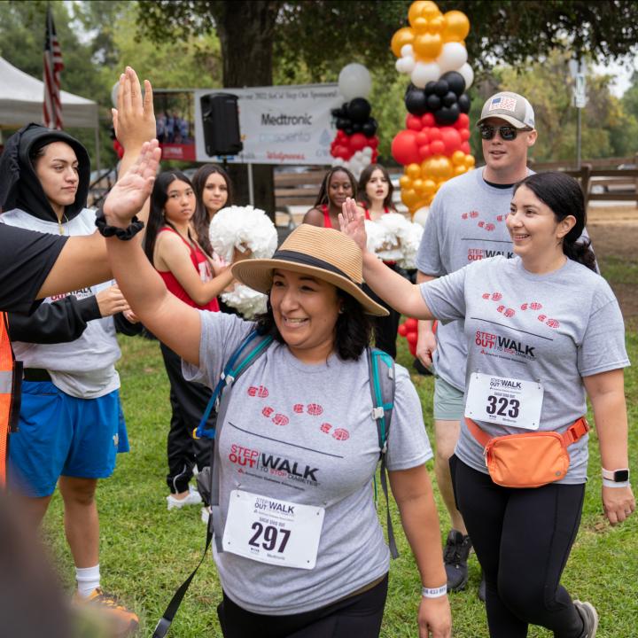 People in a community giving high fives after Step Out Walk