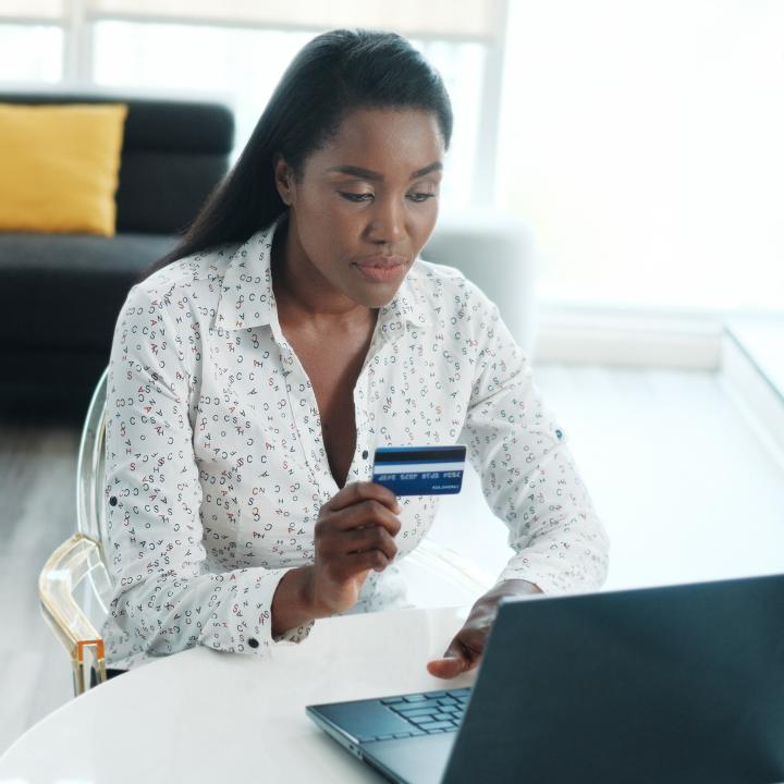 A woman filling credit card details into the computer
