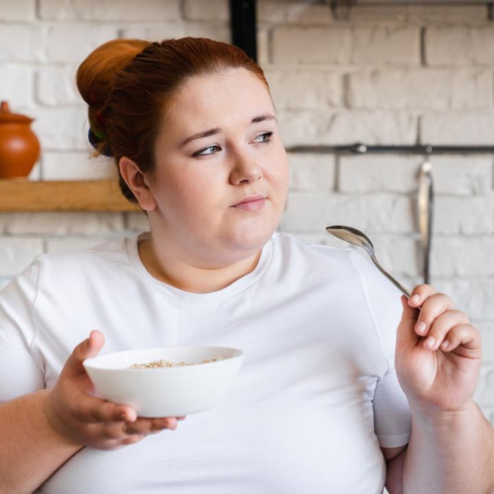 Woman looking pensive while eating