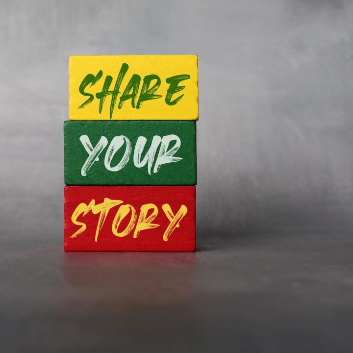 Share Your Story on yellow green red blocks on gray background