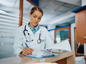 female doctor writing medical report