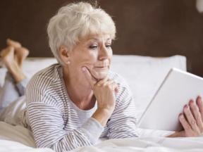 Woman reading book in bed