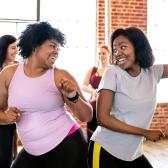 Two smiling women at exercise class