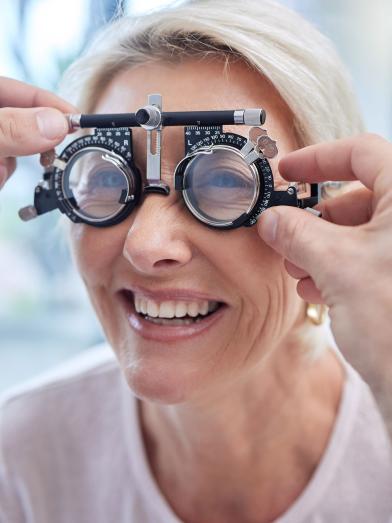 Smiling senior woman getting eye exam