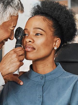 African American woman getting eye exam