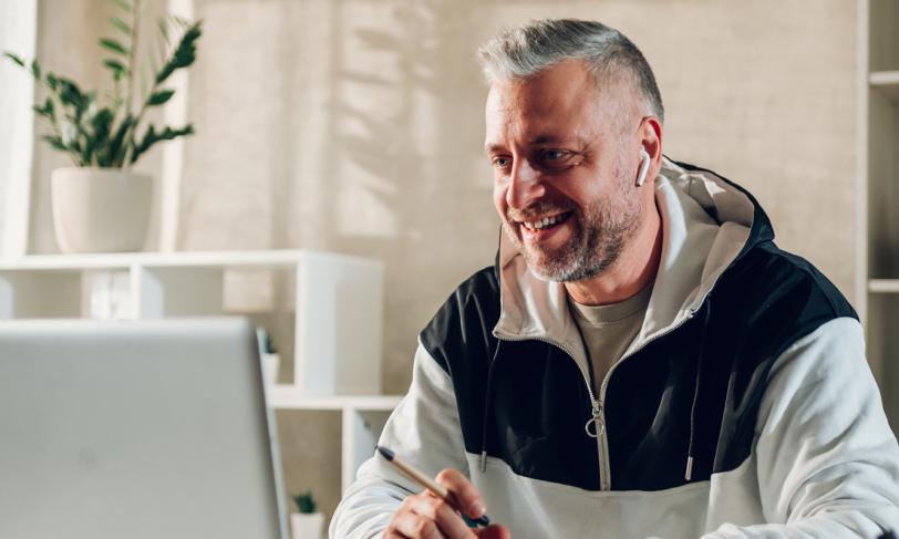 Adult Male with Earbuds on Laptop