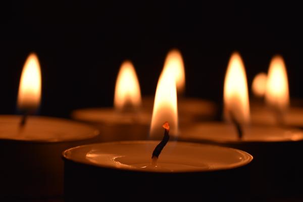 Group of lit candles at night