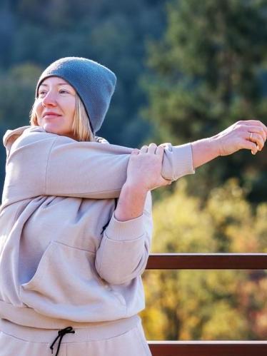 Woman stretching outdoors on Fall day