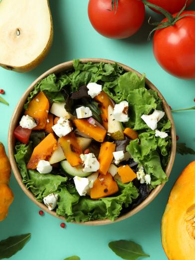 Healthy salad with pumpkin pears tomatoes