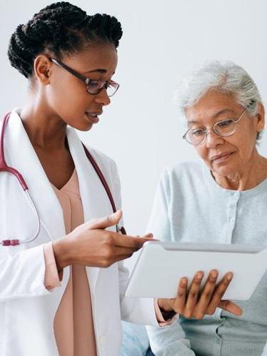 African American doctor talking to senior patient
